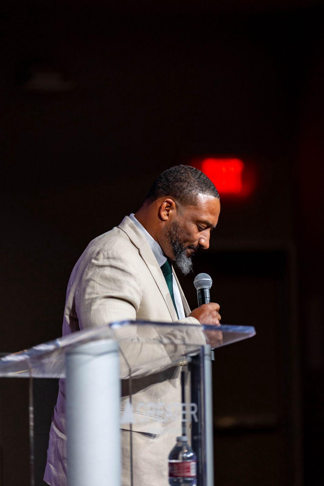 Mario Hall preaching at the podium